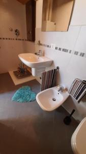 a bathroom with a sink and a toilet at La Casa Azzurra in Misano Adriatico