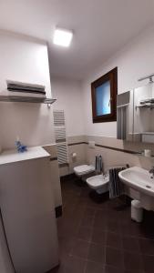 a bathroom with three sinks and two toilets at La Casa Azzurra in Misano Adriatico