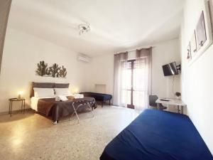 a bedroom with a bed and a large window at BARI ROOMS Central Station in Bari