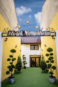 a hotel welcome sign on the side of a building at Hotel Novotheos in Oradea