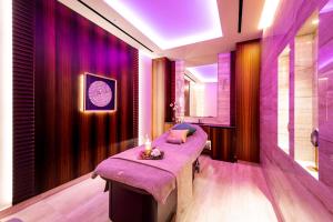 a room with purple curtains and a table with candles at Adams Beach Hotel & Spa in Ayia Napa