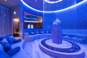 a lobby with a statue in the middle of a room at Adams Beach Hotel & Spa in Ayia Napa