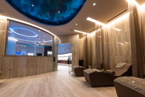 a lobby with couches and a large window at Adams Beach Hotel & Spa in Ayia Napa