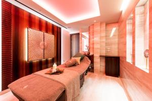 a bedroom with two beds and a fireplace at Adams Beach Hotel & Spa in Ayia Napa