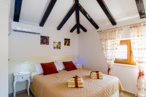 a bedroom with two beds and a window at Apartments Melany in Slano
