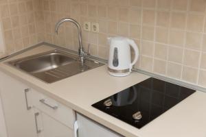 a kitchen counter with a sink and a toaster at Apartments Milana 2 in Tučepi +56 photos
