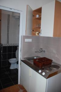 a small bathroom with a sink and a toilet at Guest House Nura in Ulcinj