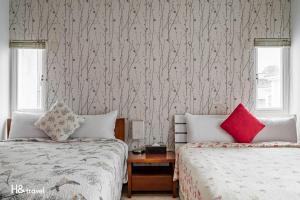 Postel nebo postele na pokoji v ubytování White Cotton Candy Homestay