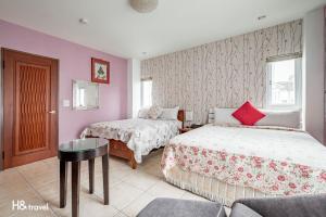 Postel nebo postele na pokoji v ubytování White Cotton Candy Homestay