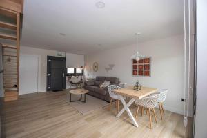 a living room with a couch and a table at Adosado-Duplex Marea Baja 2 zona de playa y montañ in Llanes