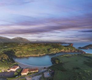 an aerial view of a body of water with mountains at Adosado-Duplex Marea Baja 2 zona de playa y montañ in Llanes