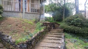 a stone retaining wall in front of a house at Maili Saba Camp in Nakuru
