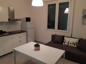 a living room with a white table and a couch at Villa Lina in Rimini