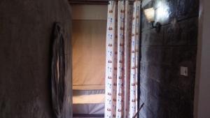 a room with a curtain and a bed with a window at Maili Saba Camp in Nakuru