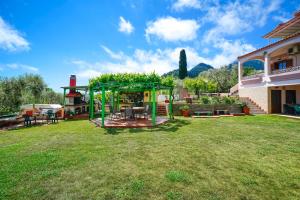 a yard with a playground in front of a house at Villa Melina 2 in Koinyra