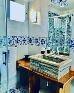 a blue and white bathroom with a sink and a mirror at L'incanto di Nausicaa in Ascea +87 photos