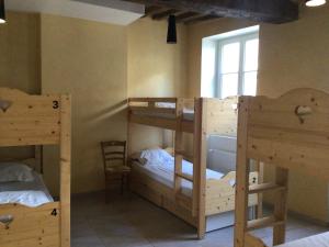 a room with three bunk beds and a window at L'auberge de Treigny in Treigny