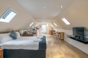 a bedroom with a bed and a living room at Victoria Court Suites - Aberdeen in Aberdeen