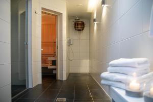 a bathroom with a shower and some towels at Hotel Restaurant Lunia in Oldeberkoop