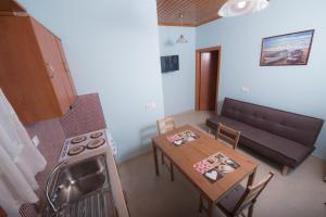 a small living room with a table and a couch at Πέτρινο σπίτι in Lazaráta