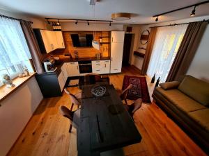 a living room with a table and a couch at Ferienhaus Winzerhaus Südsteiermark in Leibnitz