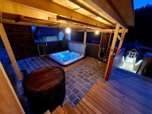 莱布尼茨Ferienhaus Winzerhaus Südsteiermark的房屋内带热水浴池的户外甲板