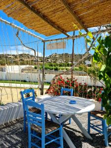 a table and two chairs under a pergola at Kalamuria Studios in Plaka