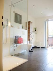 a bathroom with a shower and a tub and a sink at Ferienwohnungen Irmengard in Bernau am Chiemsee