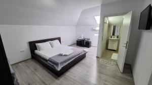 a small bedroom with a bed and a mirror at Vila Albertino in Eforie Nord +55 photos