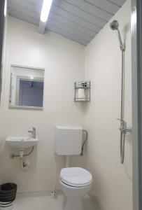 a white bathroom with a toilet and a sink at PursiSimplu ADULTS ONLY in Vama Veche