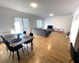 a living room with a table and chairs and a couch at Danubiana Apartments in Kladovo