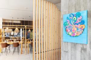 a dining room with a painting on the wall at INNSiDE by Meliá Fuerteventura – Adults Only in Costa Calma