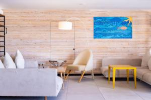 a living room with a couch and chairs and a table at INNSiDE by Meliá Fuerteventura – Adults Only in Costa Calma