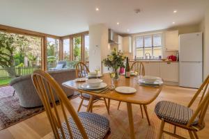 uma cozinha e sala de jantar com mesa e cadeiras em Gothic House Cottage em Clare