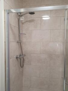 a shower with a glass door in a bathroom at Willards B&B in Bundoran