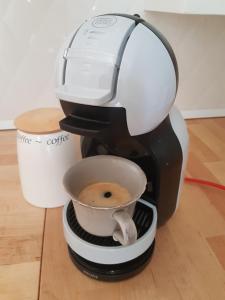 a coffee maker with a cup of coffee at Parkowa 10 przy plaży i molo in Sopot