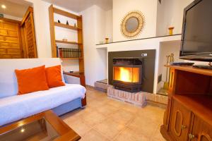 a living room with a couch and a fireplace at Casa Gabriela in Palomera