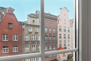 a view of buildings from a window at Elite Apartments Old Town Ogarna in Gdańsk