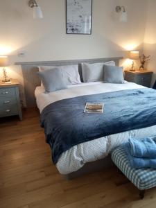 a bed with pillows and pillows on a wooden floor at Clifden Bay Lodge in Clifden