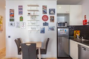 a kitchen with a table and a refrigerator at Casa Monika II - Portimão in Portimão