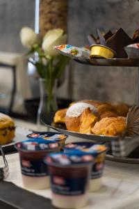 a counter with some pastries and a plate of food at Casa dAvorio in Salerno