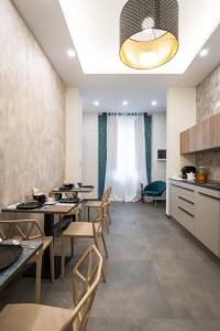 una cucina e una sala da pranzo con tavoli e sedie di Casa dAvorio a Salerno