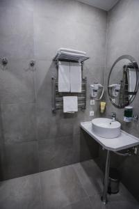 a bathroom with a sink and a mirror at Sleepers Avia Hotel DME in Domodedovo