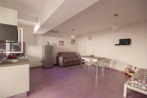 a kitchen and living room with a couch and a table at B&B Tor Di Lupo in Mattinata