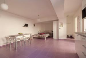 a living room with a table and chairs and a couch at B&B Tor Di Lupo in Mattinata