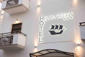 a sign for the havanaolis hotel on the side of a building at Hotel La Caravella in Vieste