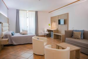 a hotel room with a bed and a couch at Pegasus Hotel in Sassari +161 photos