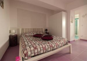 a bedroom with a bed with two pillows on it at B&B Tor Di Lupo in Mattinata