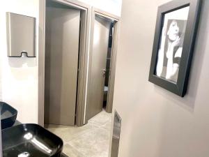 a bathroom with a black sink and a mirror at Urban Habitat Capsule Beds in Nicosia