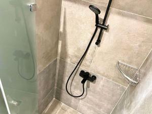 a shower with a blow dryer in a bathroom at Urban Habitat Capsule Beds in Nicosia +31 photos